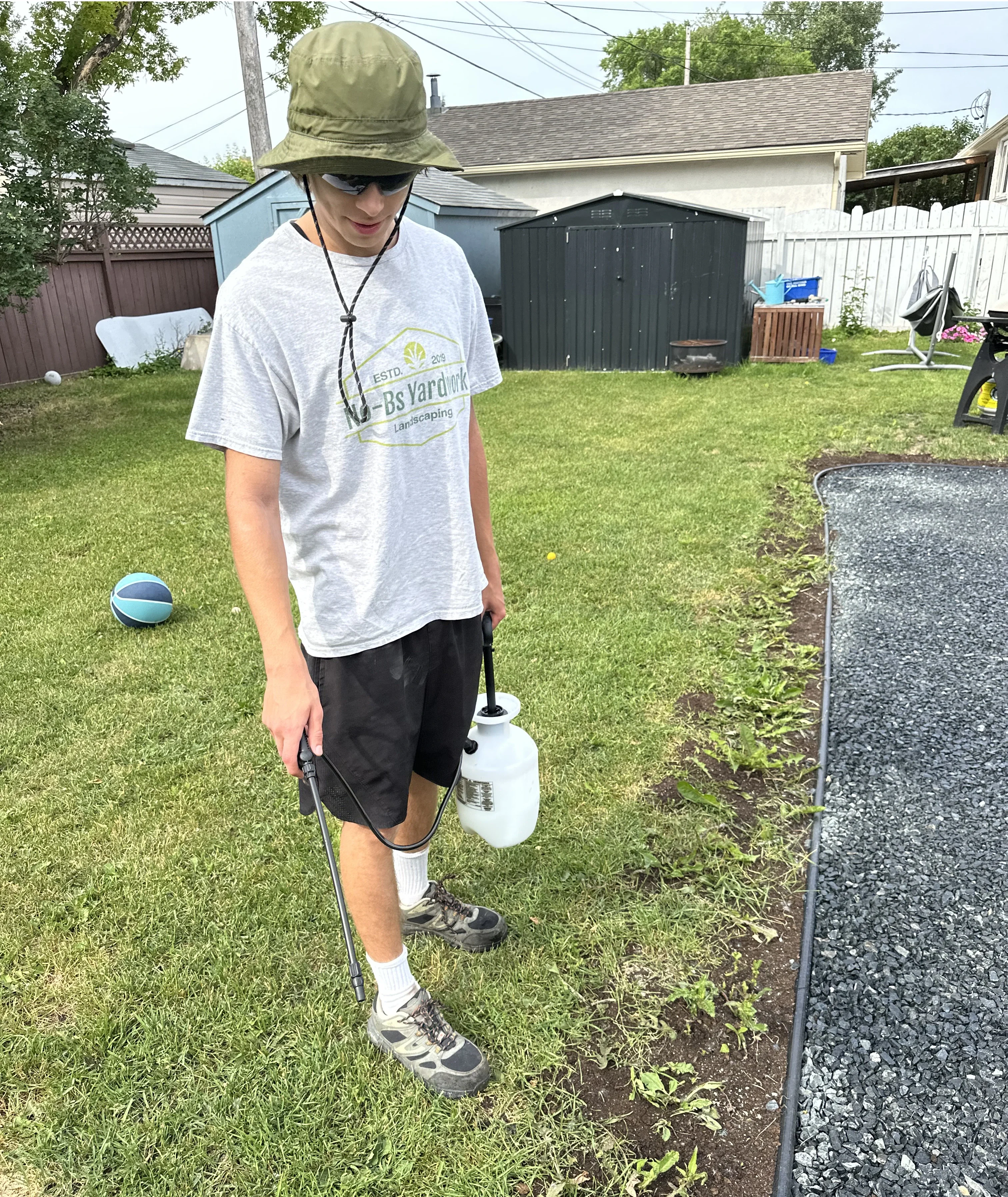 Weed control treatment being applied to a Winnipeg lawn